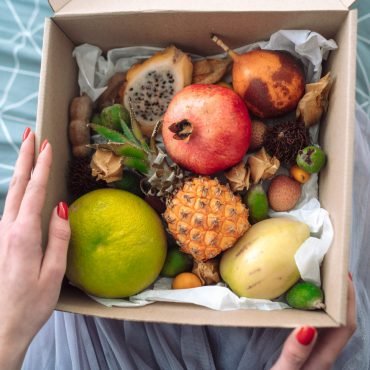 Box of fruit from someone in the hands, a close angle
